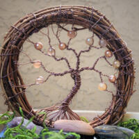 old grapevine wreath wrapped with rustic brown wire adorned with shades of brown glass beads 